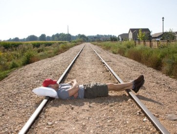 Man Sleeping on Railroad Tracks